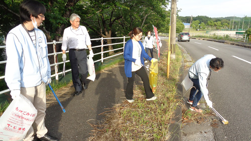 社員が会社近くの歩道で清掃活動を行っている様子